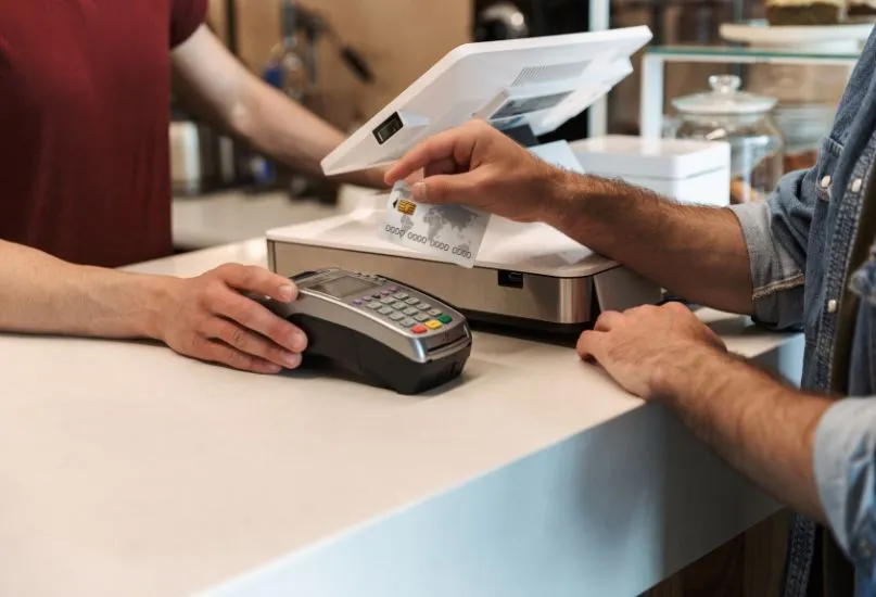 customer paying for a charge with a credit card on a terminal