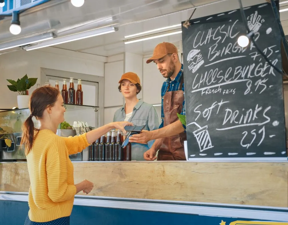 food truck worker taking payment on a terminal